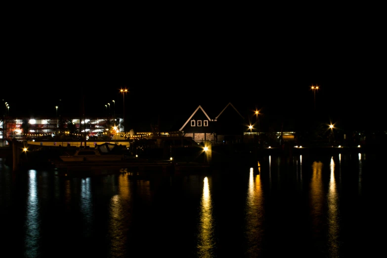 the lights of a house are reflected in water