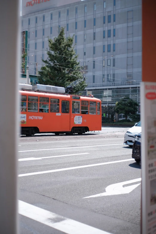 a red bus driving on a city street