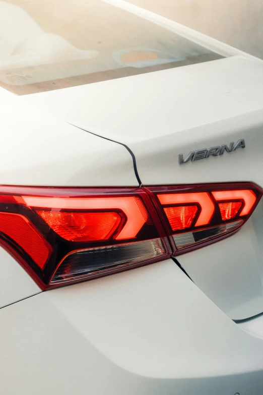 the taillights on a white car in a parking lot