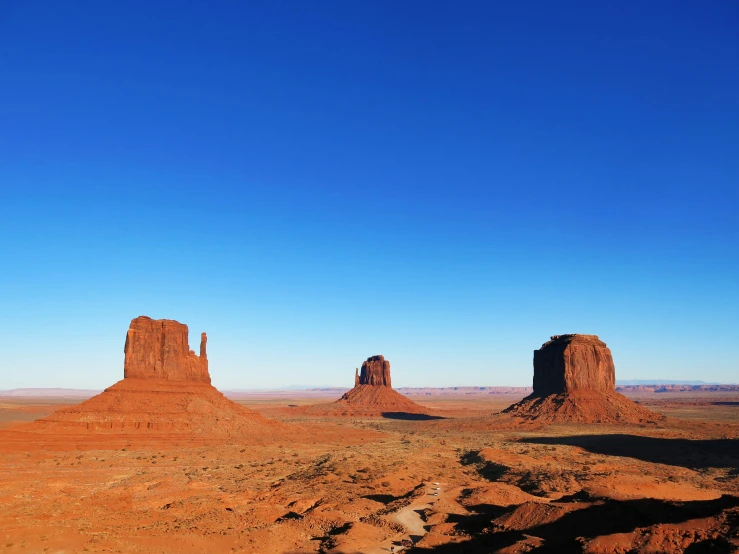 some very nice rocks in the desert under a blue sky