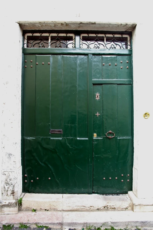 a green door that is in front of a white wall