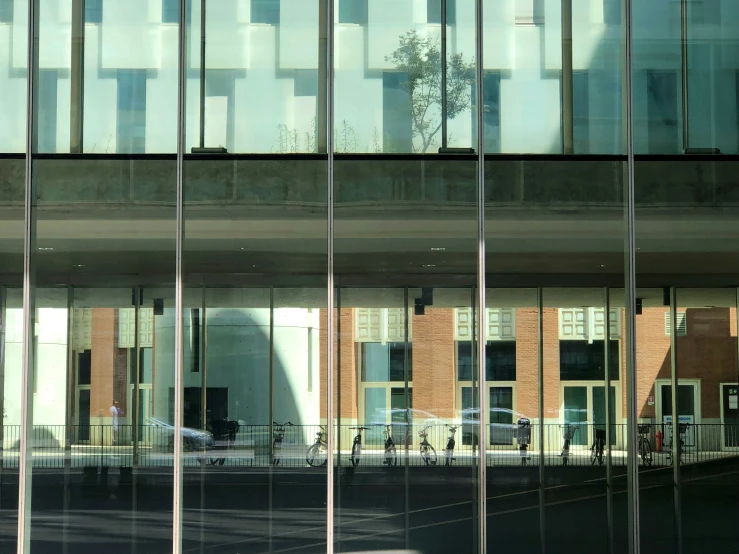 reflections of buildings in glass at the window