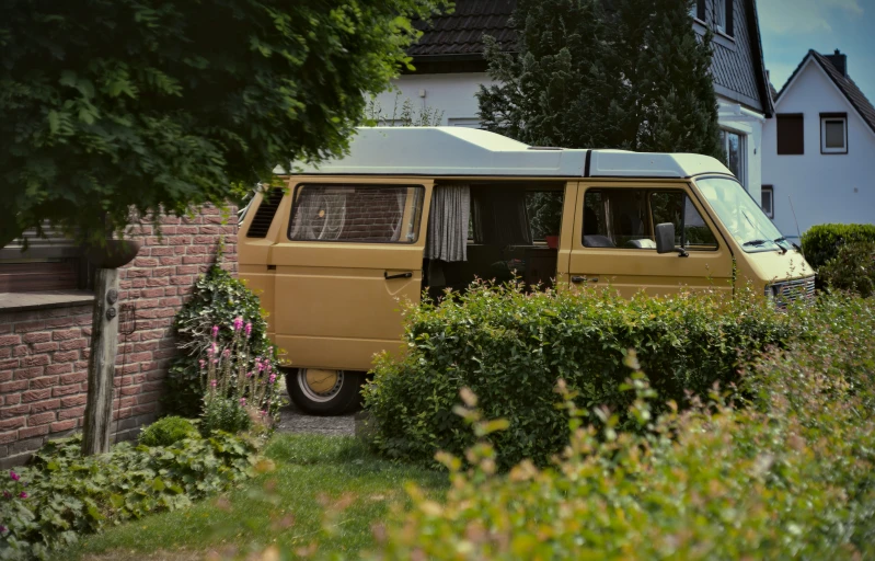 a bus that is sitting by some bushes