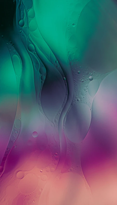 an image of colorful fluid paint with drops on it