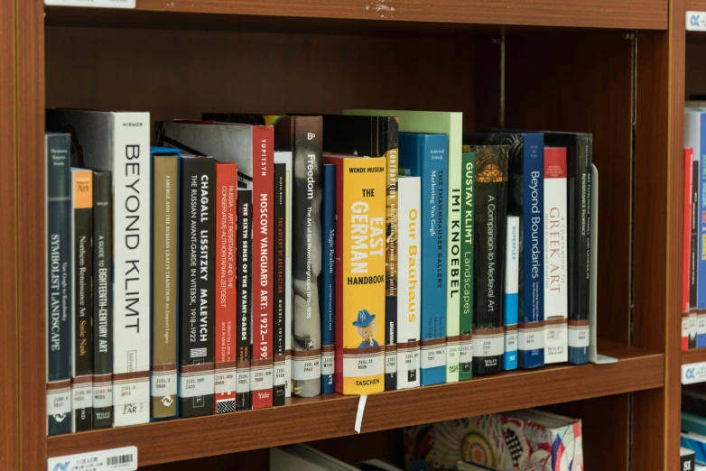 a brown shelf filled with books next to a liry