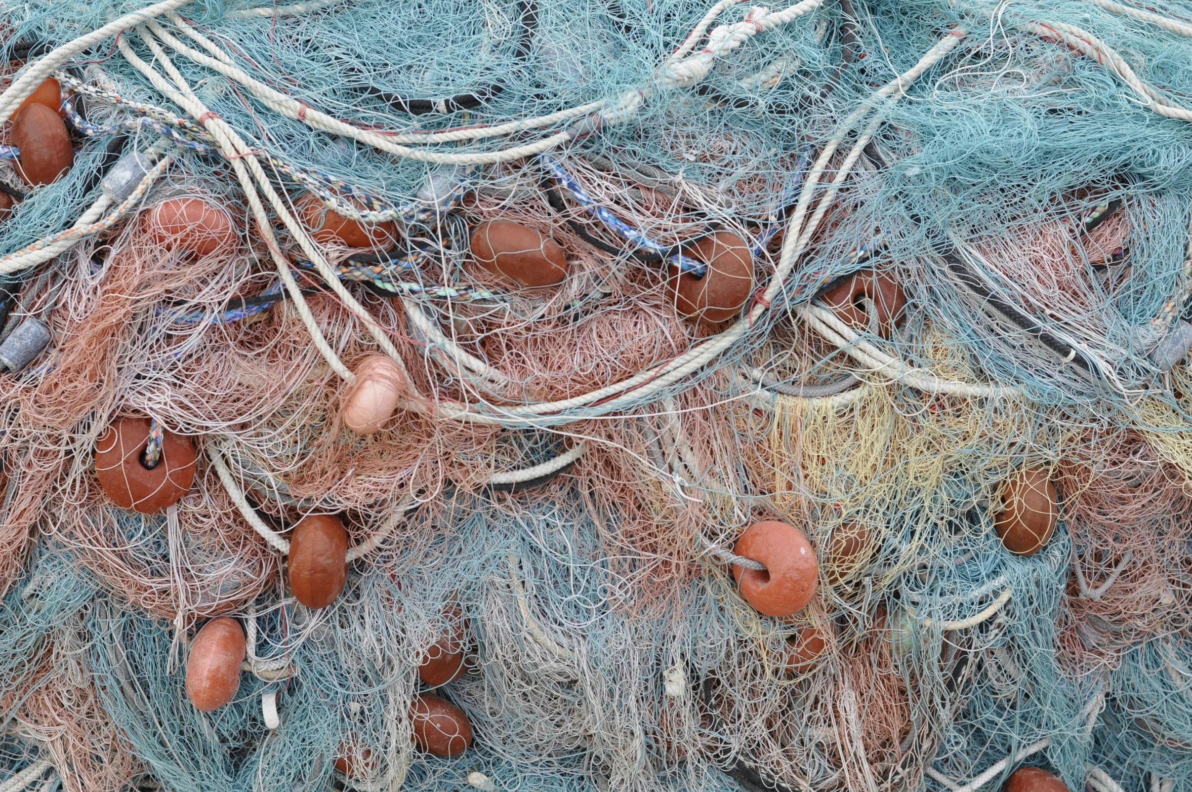 nets containing fishing implements and fishing floats are on the ground