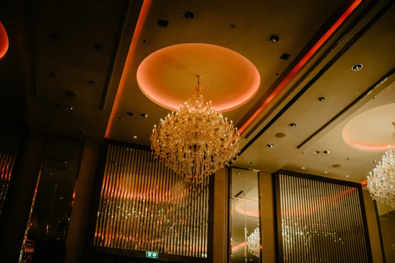 a chandelier hanging from the ceiling of a dimly lit hall