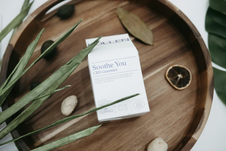 some flowers and a box on a wooden tray