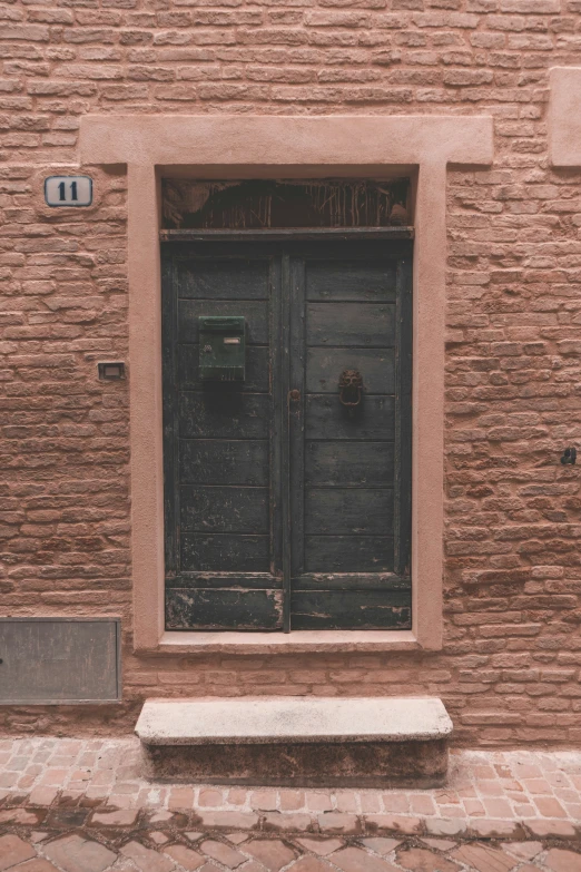 an old building with bricked up doors and stone bench