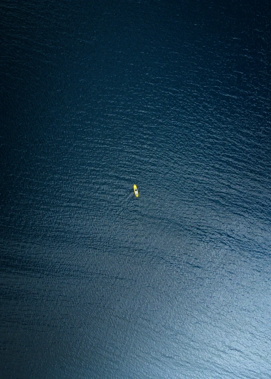 a group of people are in the middle of the ocean with a raft