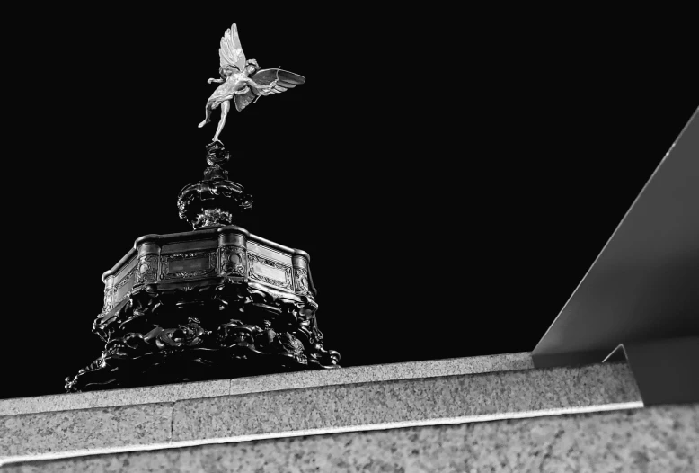 a small bird is perched on the top of a building