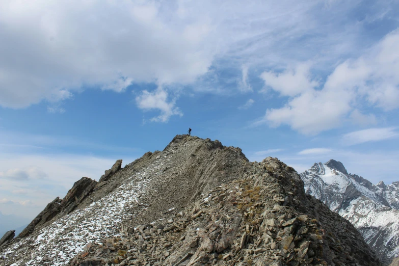 a man standing on the top of a rocky mountain