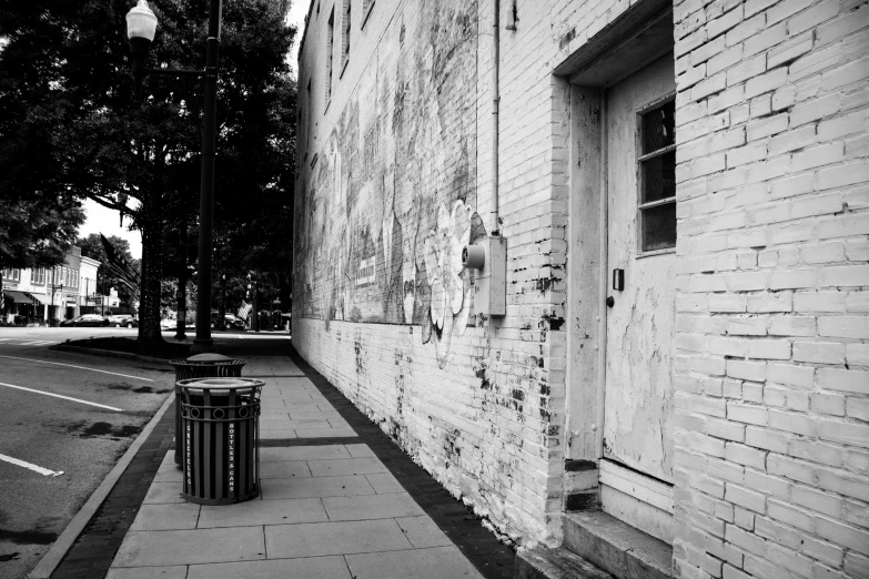 an empty city sidewalk next to a building