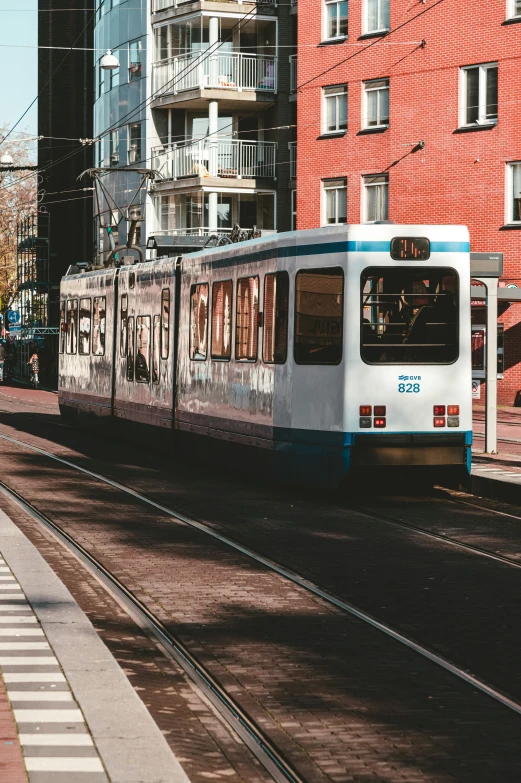 a public transportation trolley is going down a city street