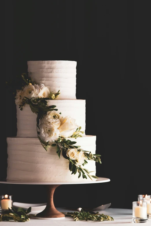 the three tier cake with flowers is white