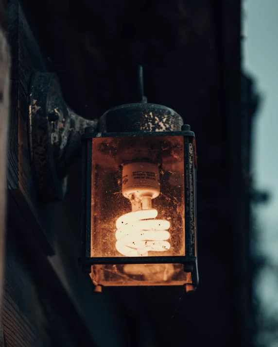 a lantern in the shape of a hand holding an item with one hand on it