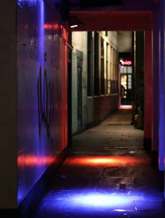 the sidewalk leading to the front door of a building with graffiti on it