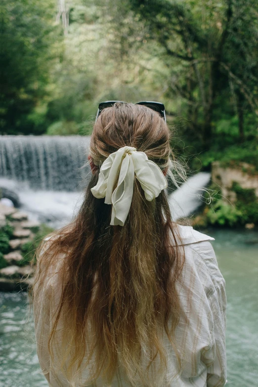 a woman with long hair and a bow in her hair