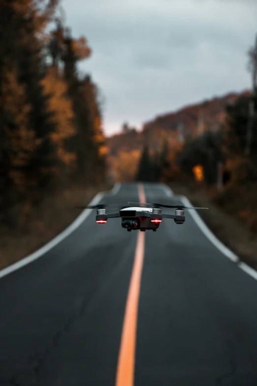 an extremely long stretch of road surrounded by trees