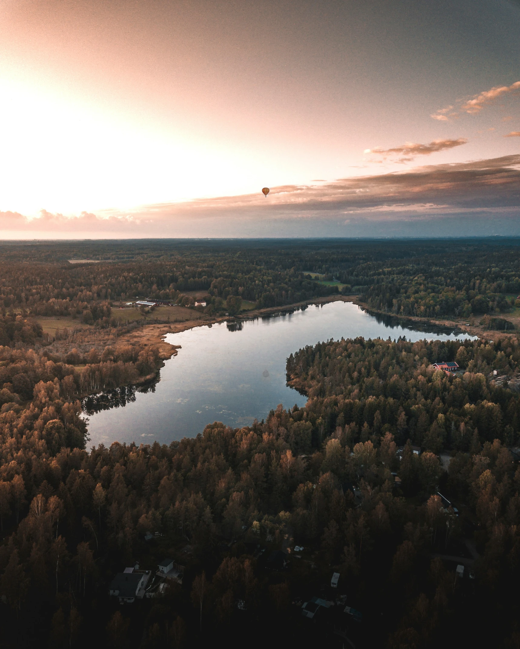 an aerial view of a body of water with trees in the foreground