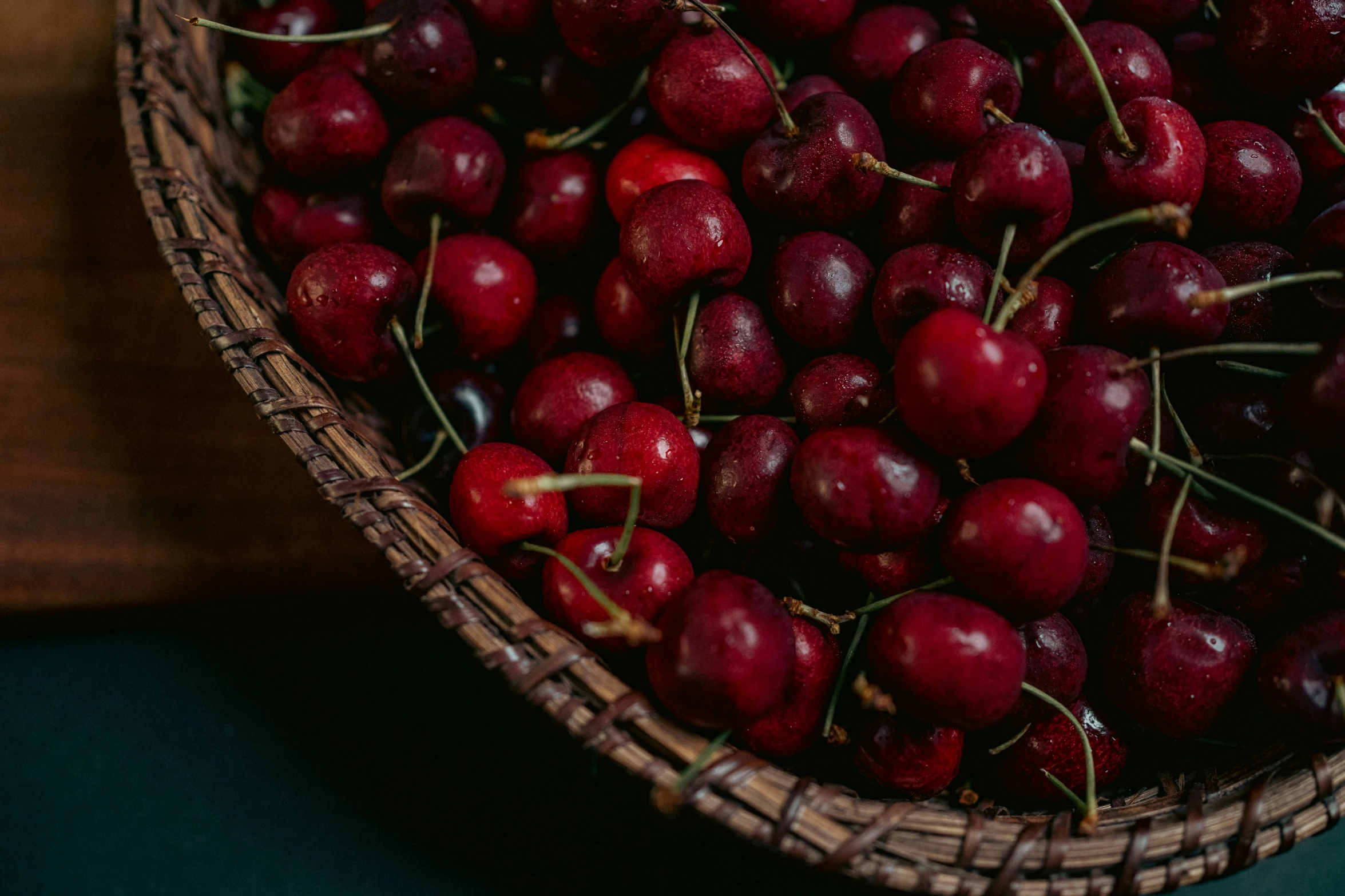 some small, dark red cherries in a basket