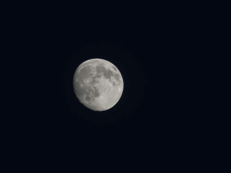 a big full moon shining brightly in the dark sky