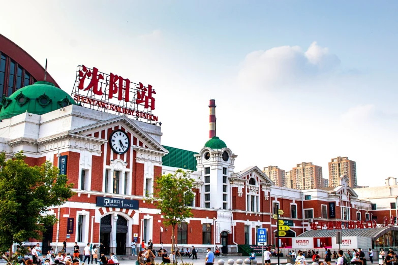 people walk in front of the colorful building in the city