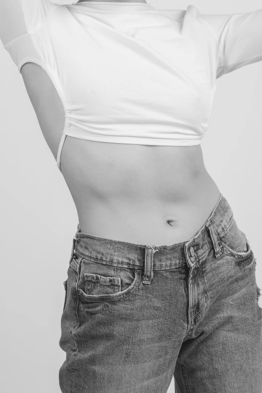 a person with a very thin stomach and wearing jeans