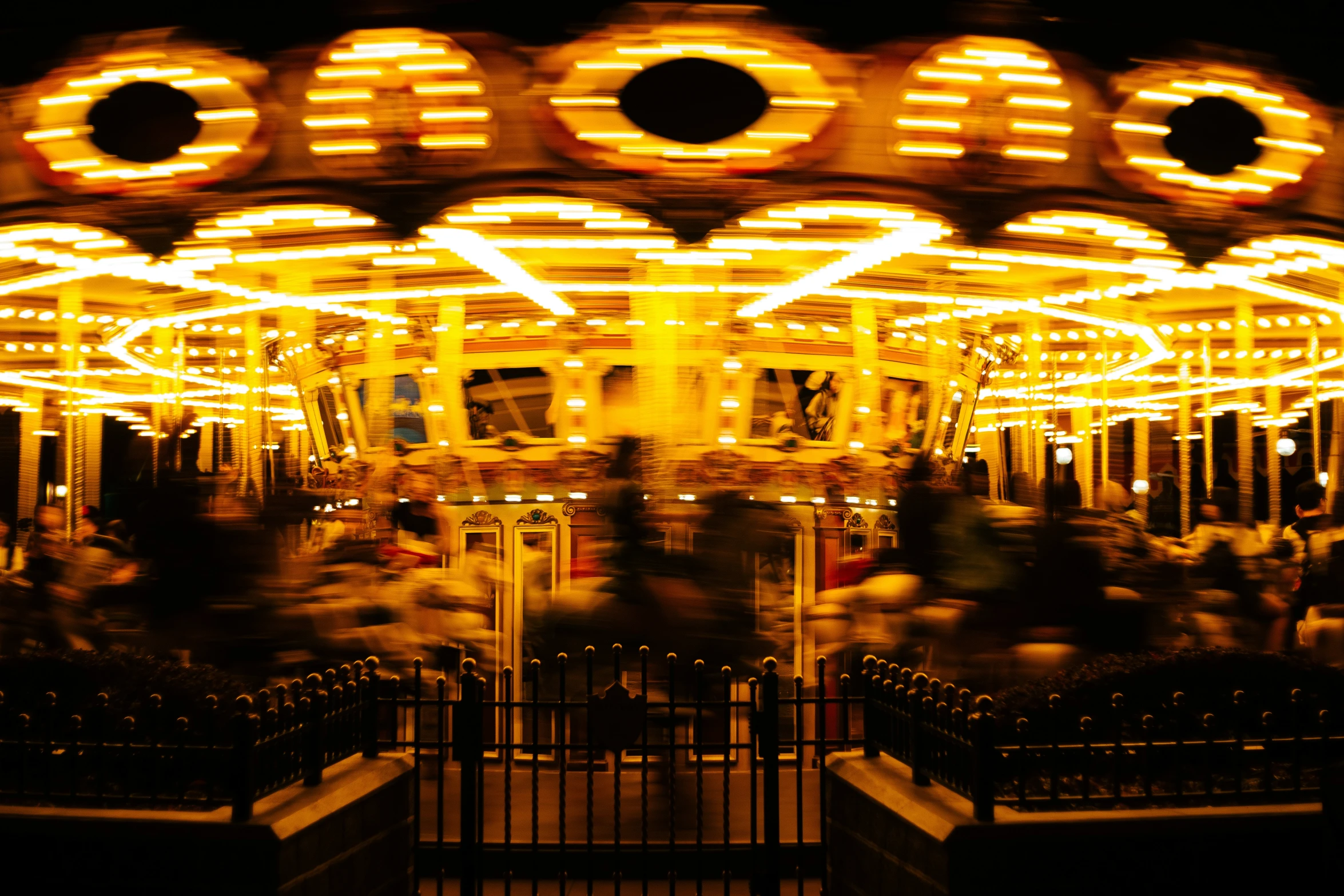 the ferris wheel is lit up at night