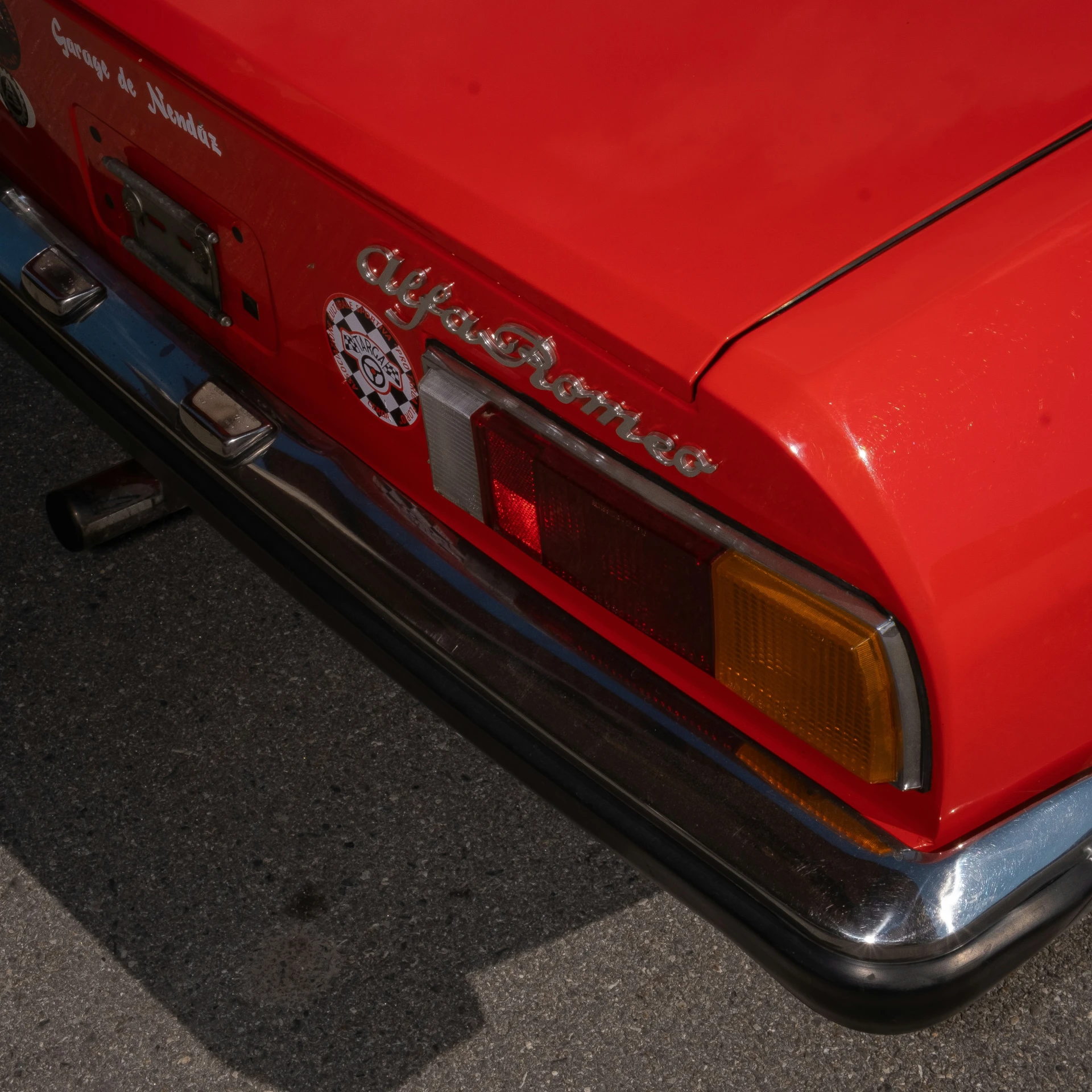 a classic red car parked in the street