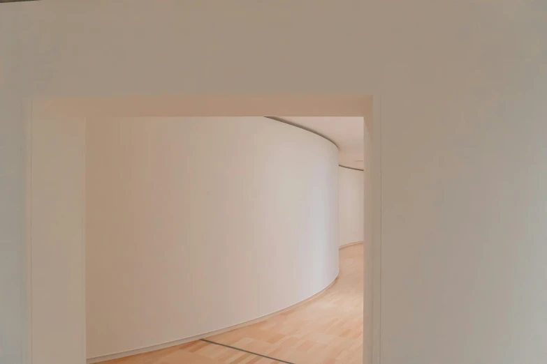 an empty room with curved walls and a floor