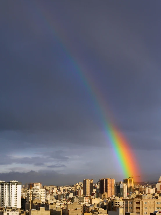 the view from the roof of a tall building with a rainbow on it