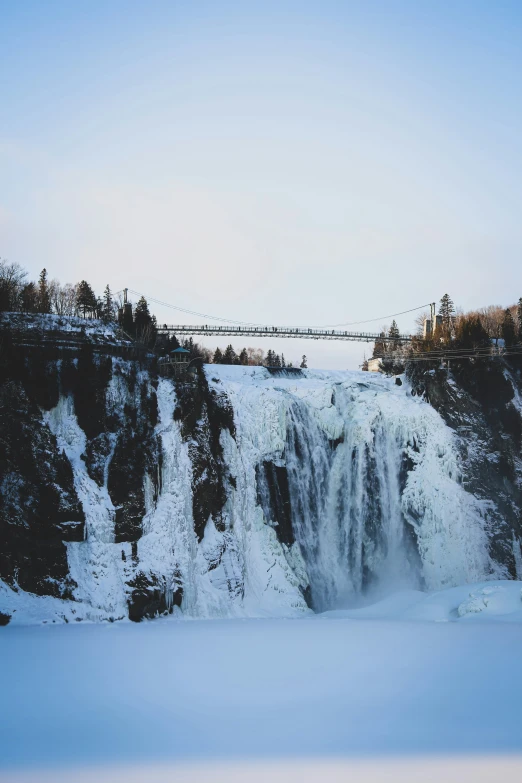 a frozen waterfall near the edge of some trees