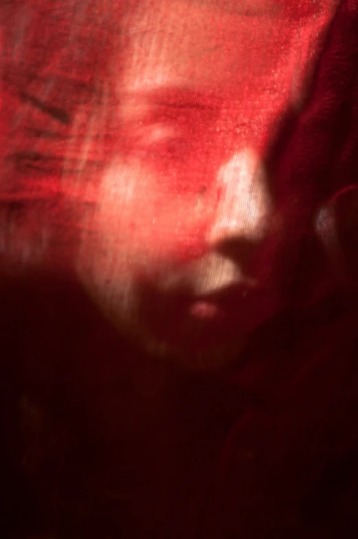 a blurry image of a woman's face as she stares straight ahead