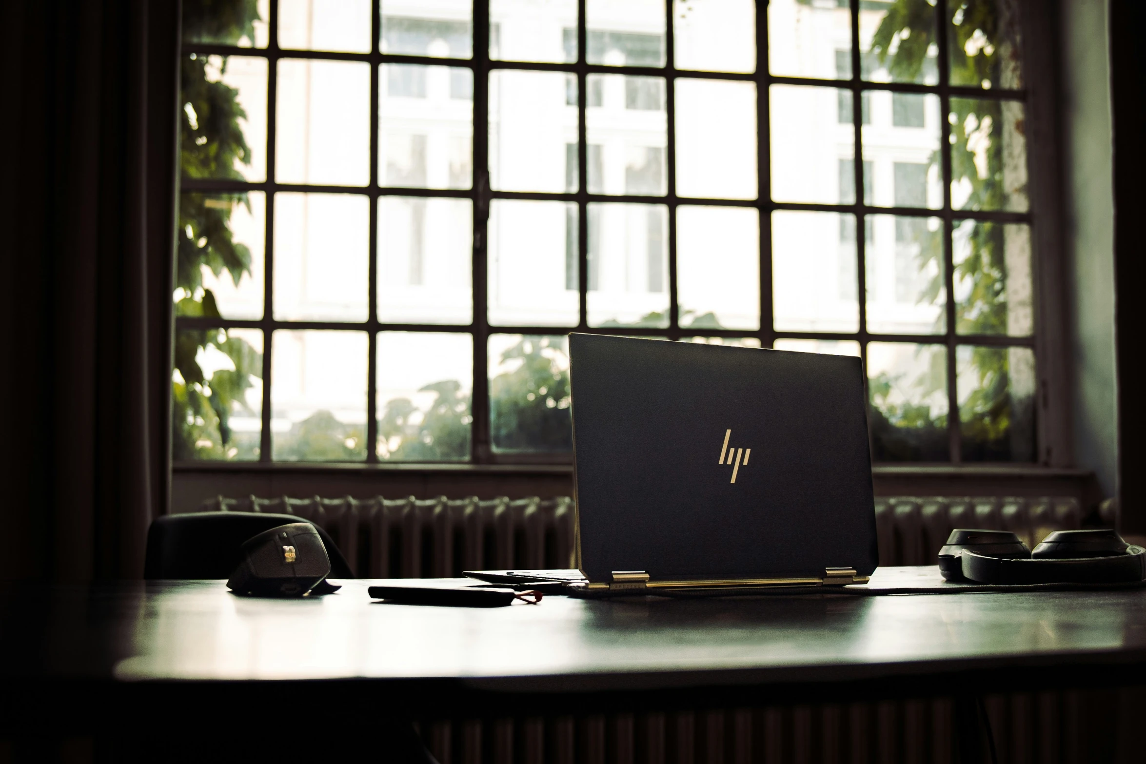 a laptop on a table in front of a window