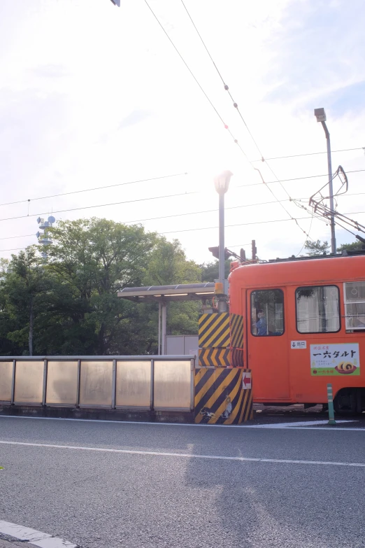 an orange bus that is going around a curve