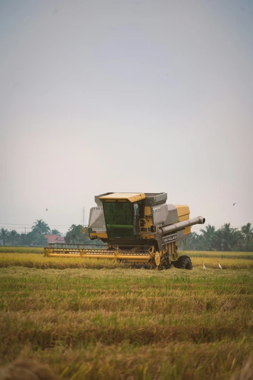 a large combine being worked in a field