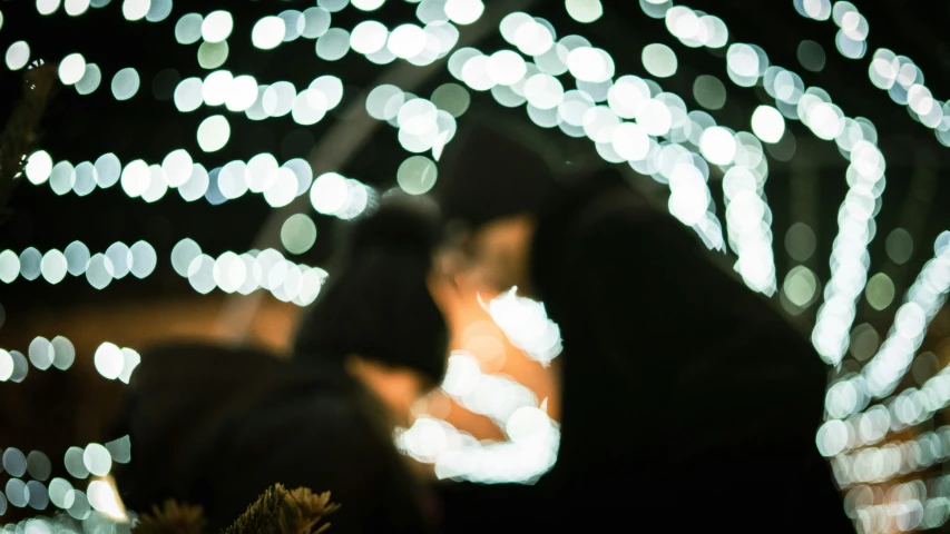 a person standing on a street holding a lit item