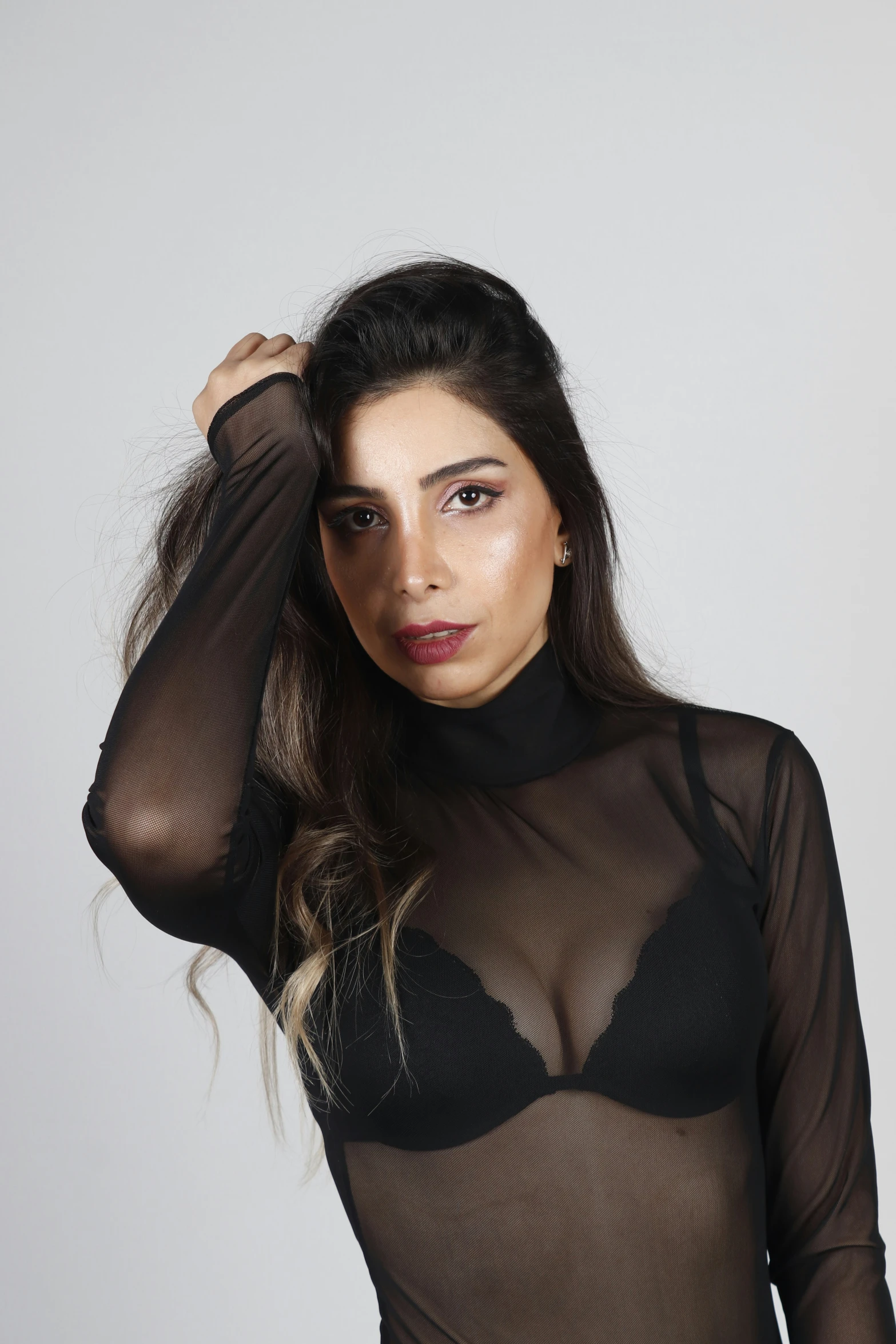 a woman in black sheer lingerie with long sleeves