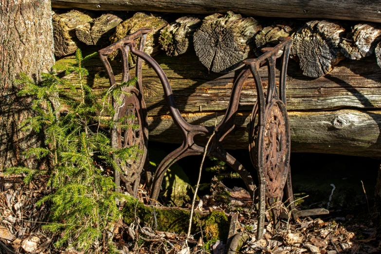 an old metal chair laying in the woods