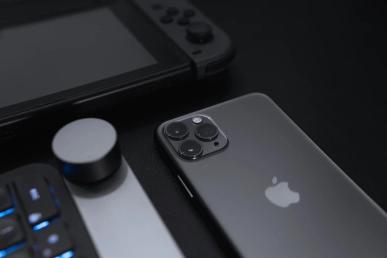 the new iphone is laying beside a gaming controller