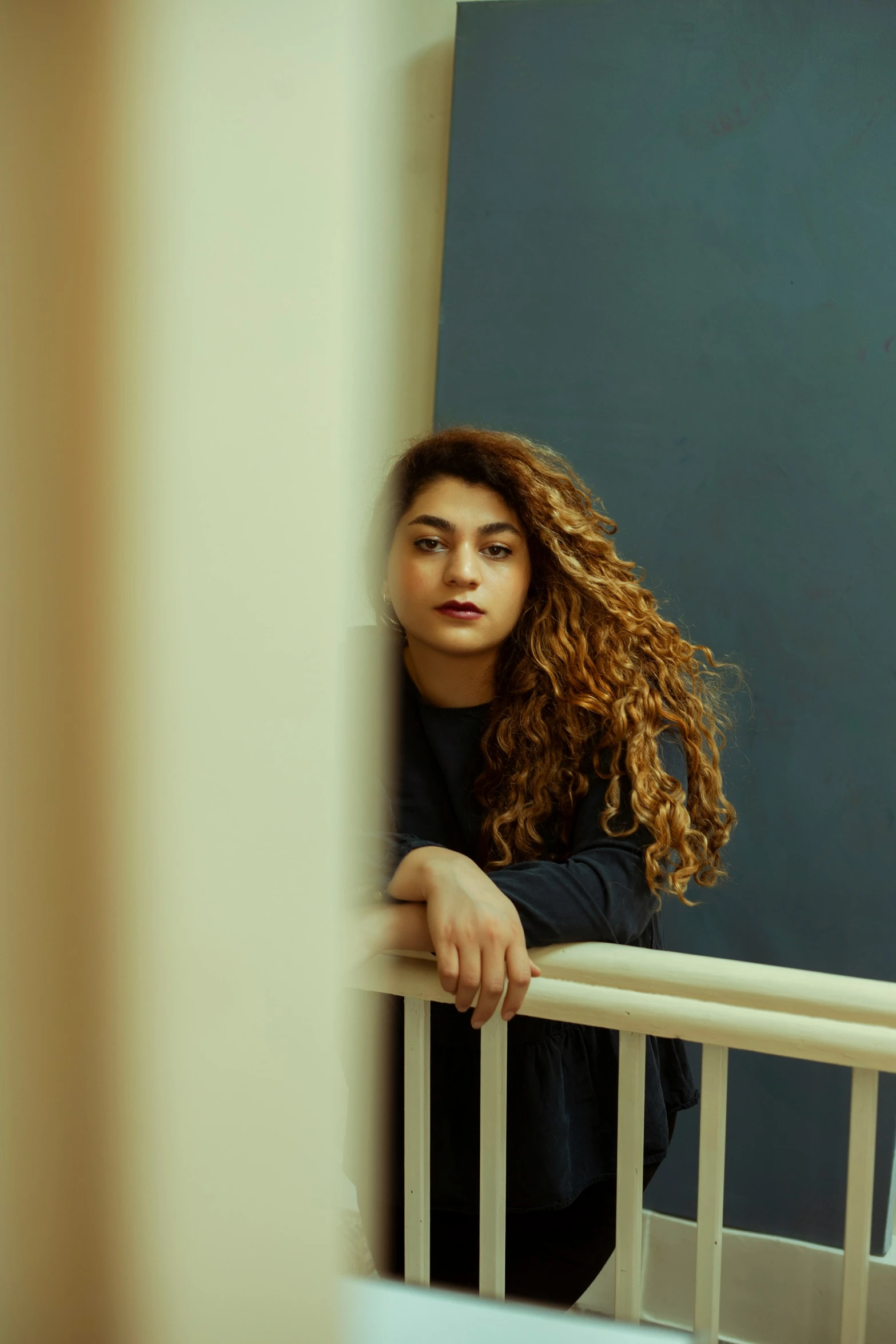 a woman sitting in her crib with her hair blowing