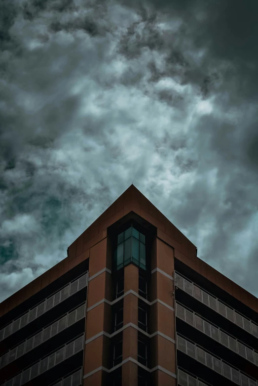 an architectural structure at night under a cloudy sky