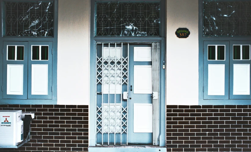 a red brick building with two black doors