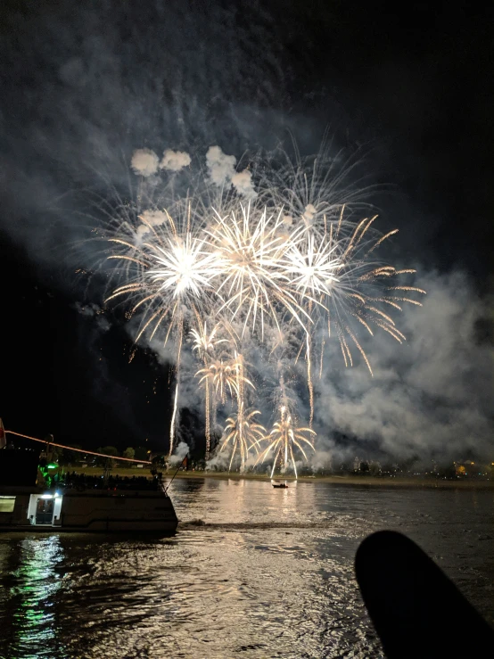 the fireworks are in the sky above the water