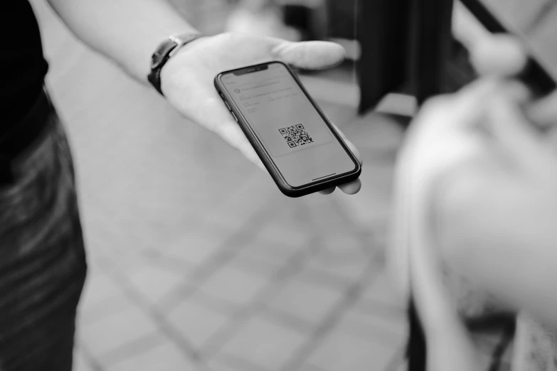 a person holding up a cell phone in the air