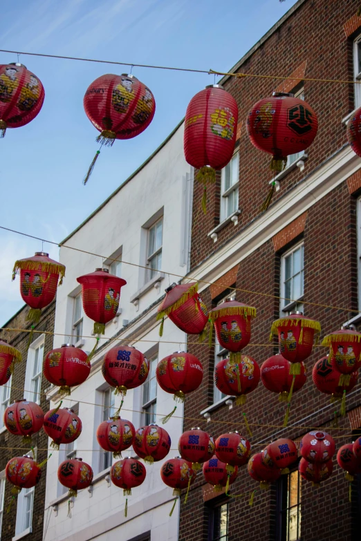 lots of lanterns are hanging down outside of the building