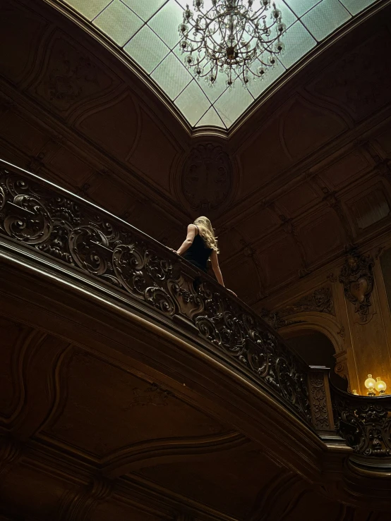 a woman walking up the side of a very high stair