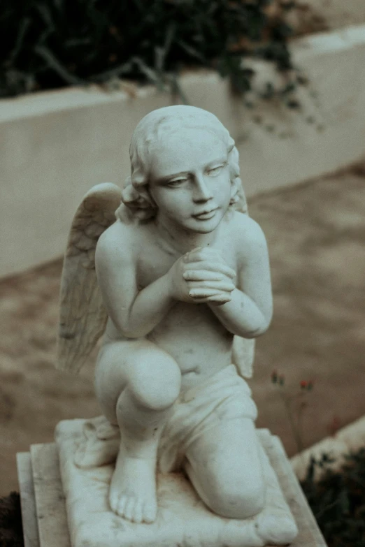 a statue of an angel is sitting on a base