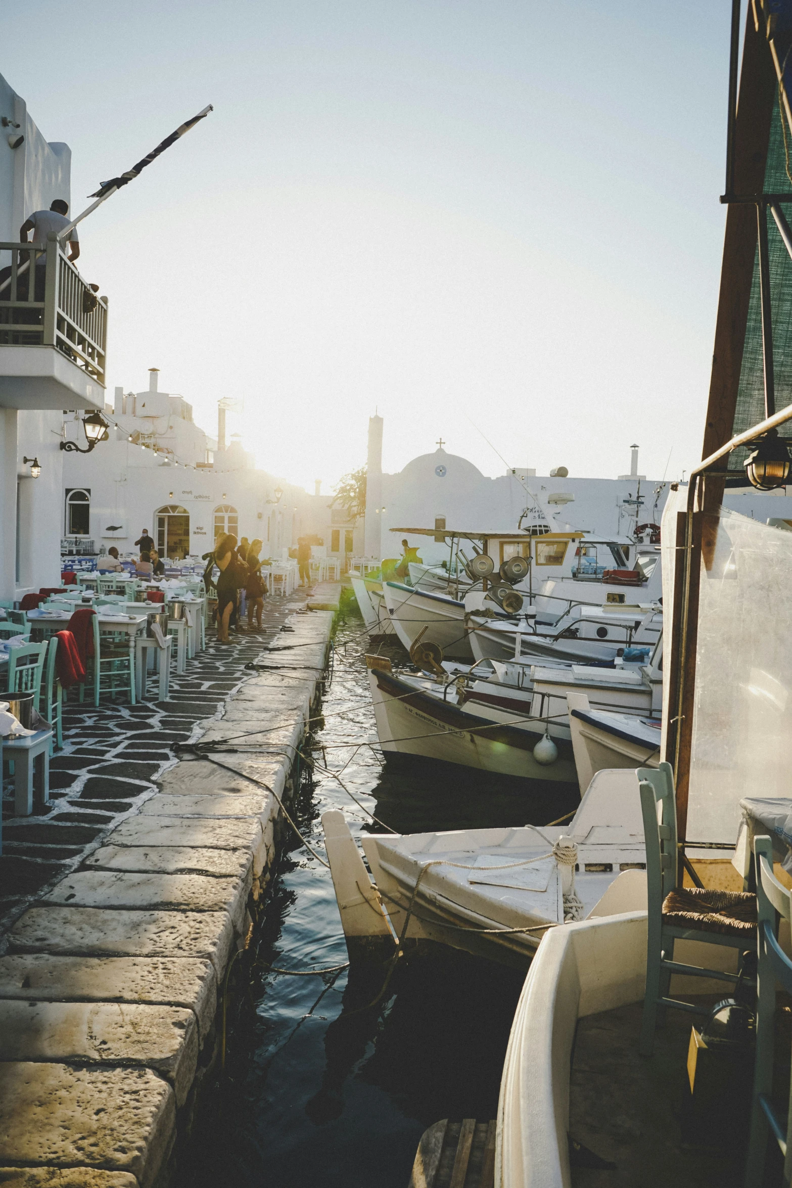 a dock with two rows of boats in front of it